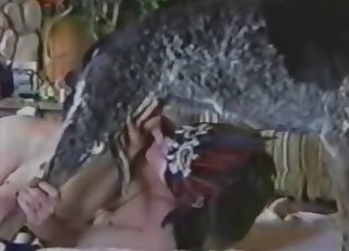 Masked babe with perky breasts deepthroating a dog's nice penis